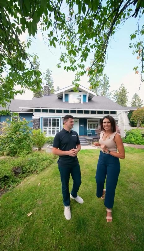 Real estate professionals standing in front of luxury home